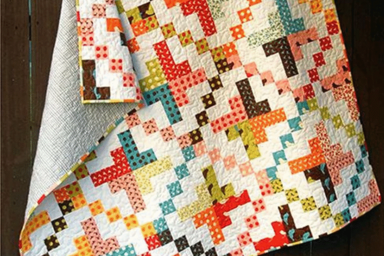 jelly roll quilt with oranges, greens and browns