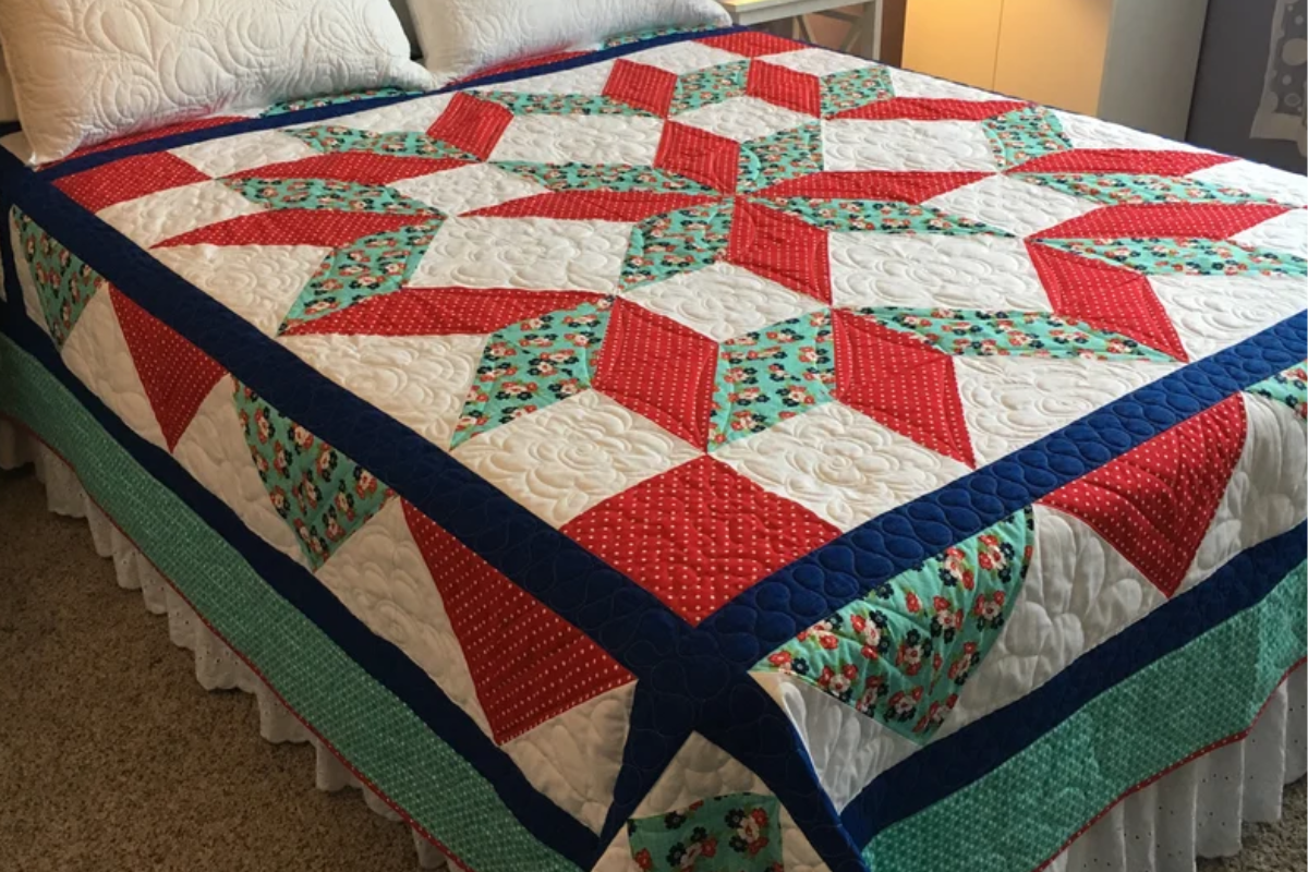 red and green star quilt pattern on a bed