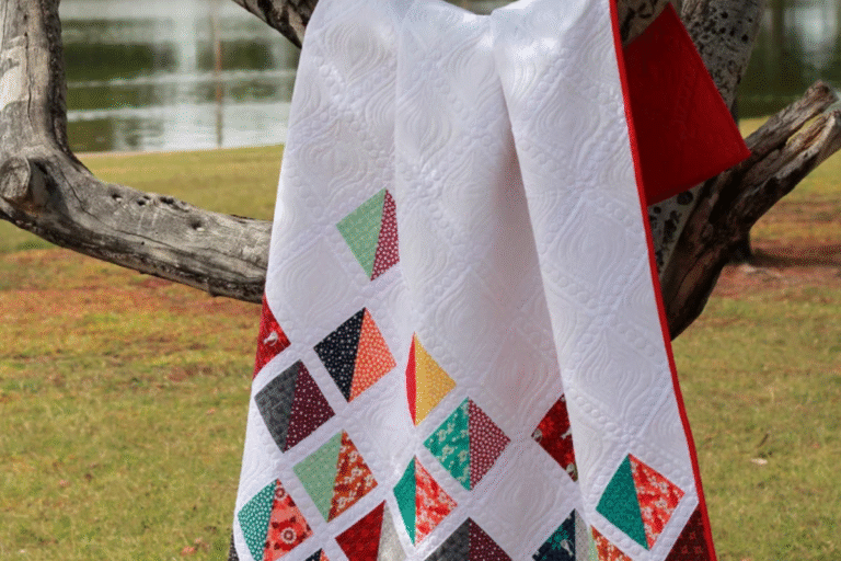 Half square triangle quilt pattern with white upper and colorful blocks on bottom